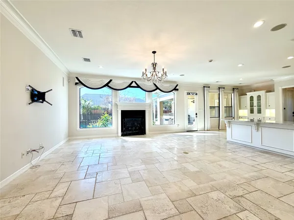 a view of an empty room with a fireplace and a window
