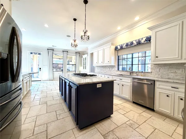a kitchen with stainless steel appliances kitchen island granite countertop a sink and cabinets