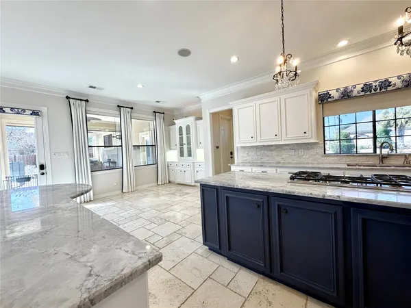 a large kitchen with stainless steel appliances kitchen island granite countertop a large counter top and a view of living room