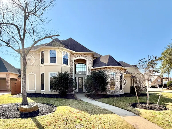a large house with a big yard and large trees