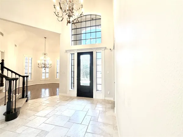 a large hall with a fireplace and a chandelier