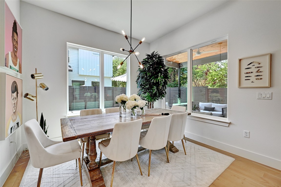 2909 Kuhlman Avenue, Unit 1 Austin, TX 78702 - Photo 12 of 40 a dining room with furniture a chandelier and window