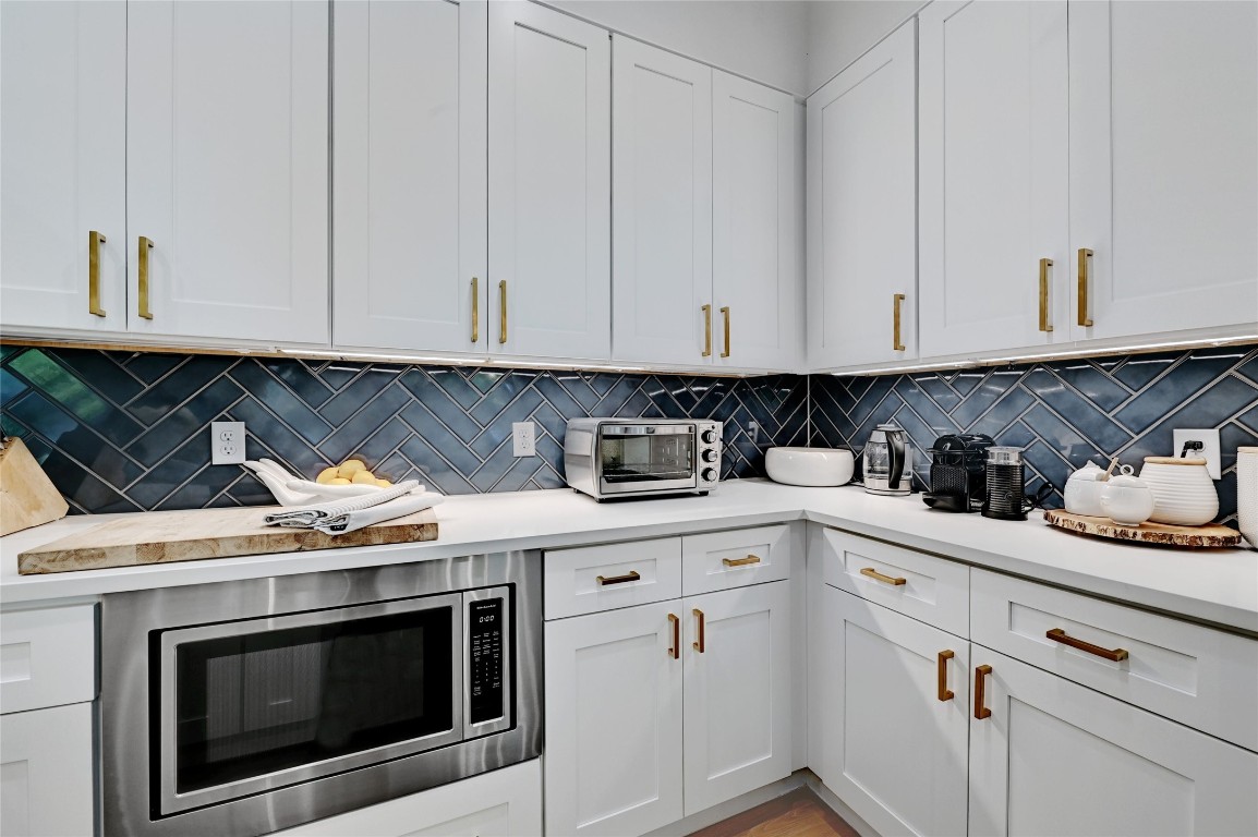 2909 Kuhlman Avenue, Unit 1 Austin, TX 78702 - Photo 16 of 40 a kitchen with granite countertop white cabinets and stainless steel appliances