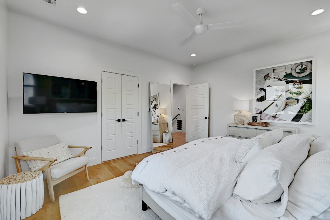 2909 Kuhlman Avenue, Unit 1 Austin, TX 78702 - Photo 19 of 40 a spacious bedroom with a bed and a flat screen tv