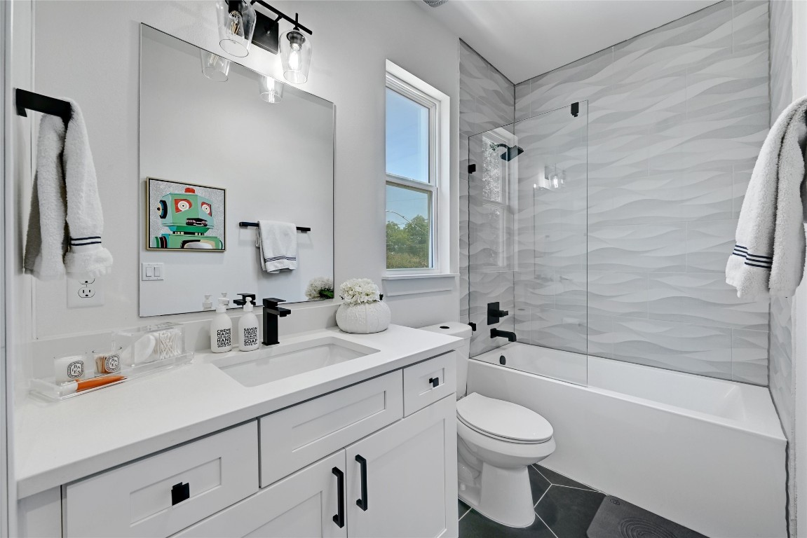 2909 Kuhlman Avenue, Unit 1 Austin, TX 78702 - Photo 24 of 40 a bathroom with a sink a toilet and shower