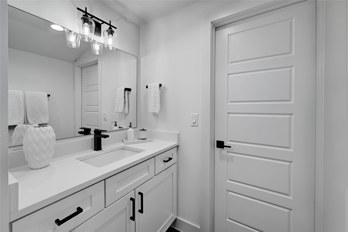 2909 Kuhlman Avenue, Unit 1 Austin, TX 78702 - Photo 31 of 40 a bathroom with a sink a vanity and a mirror