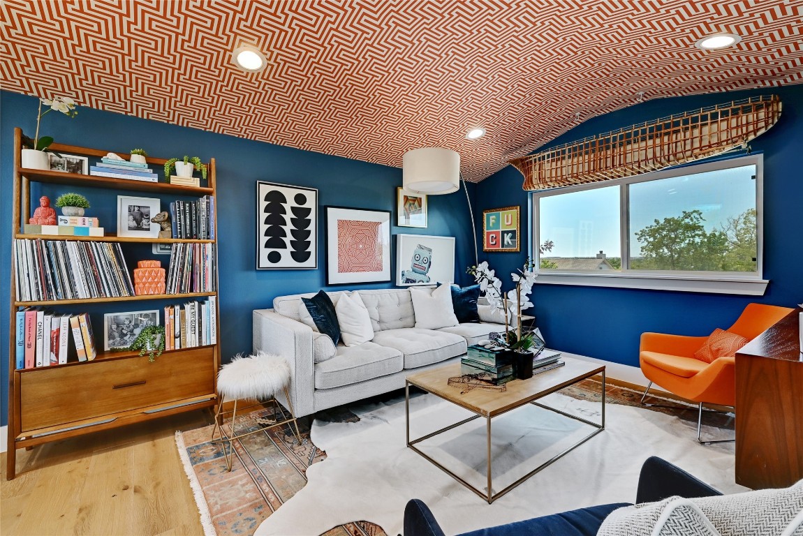 2909 Kuhlman Avenue, Unit 1 Austin, TX 78702 - Photo 32 of 40 a living room with furniture a rug and a book shelf