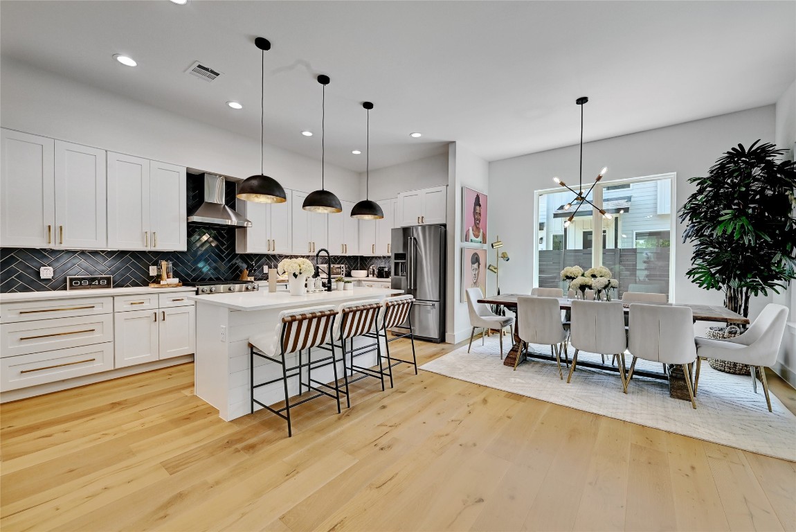 2909 Kuhlman Avenue, Unit 1 Austin, TX 78702 - Photo 10 of 40 a kitchen with kitchen island granite countertop white cabinets and refrigerator