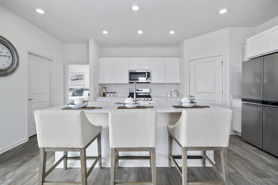 799 Mesa Lane Pingree Grove, IL 60140 - Photo 28 of 54 a kitchen with kitchen island granite countertop a dining table chairs refrigerator and cabinets