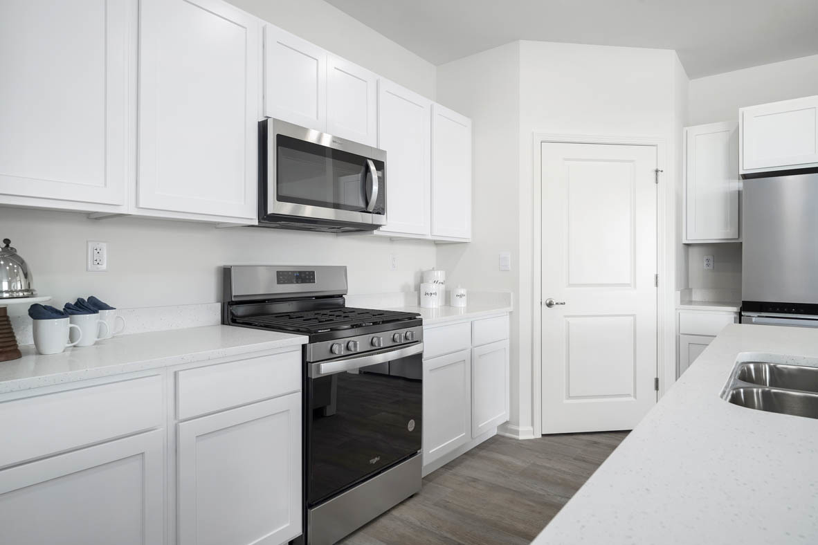 799 Mesa Lane Pingree Grove, IL 60140 - Photo 30 of 54 a kitchen with white cabinets and stainless steel appliances