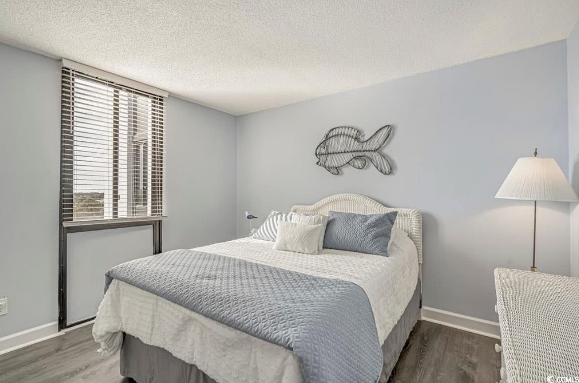 601 Mitchell Drive, Unit 1103 Myrtle Beach, SC 29577 - Photo 13 of 25 Bedroom featuring a textured ceiling and wood finished floors