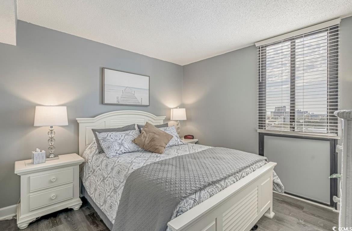 601 Mitchell Drive, Unit 1103 Myrtle Beach, SC 29577 - Photo 14 of 25 Bedroom with a textured ceiling and wood finished floors