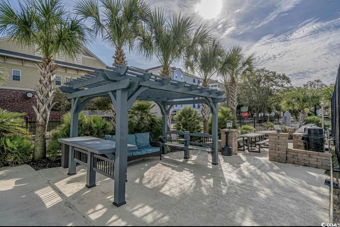 601 Mitchell Drive, Unit 1103 Myrtle Beach, SC 29577 - Photo 22 of 25 Surrounding community with a patio, a pergola, an outdoor hangout area, area for grilling, and outdoor dining space