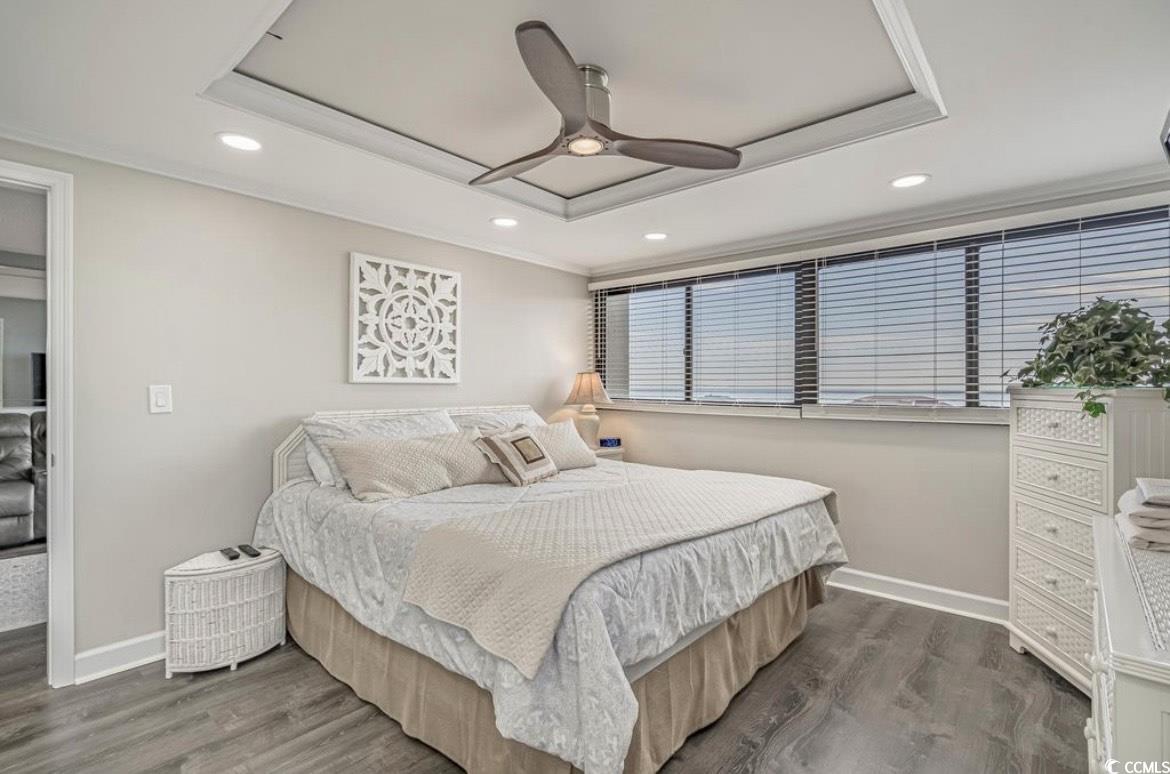 601 Mitchell Drive, Unit 1103 Myrtle Beach, SC 29577 - Photo 9 of 25 Bedroom with a raised ceiling, recessed lighting, ceiling fan, ornamental molding, and wood finished floors