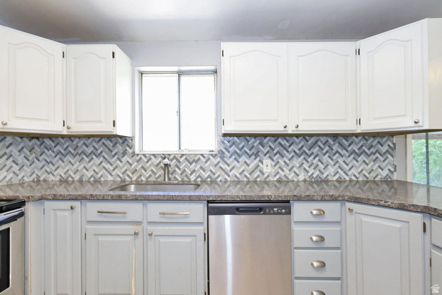 1272 Cook Street Ogden, UT 84404 - Photo 18 of 58 Kitchen with two-tone cabinetry, a herringbone tile backsplash, and a stainless steel sink