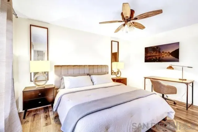 a bedroom with a bed and a flat screen tv