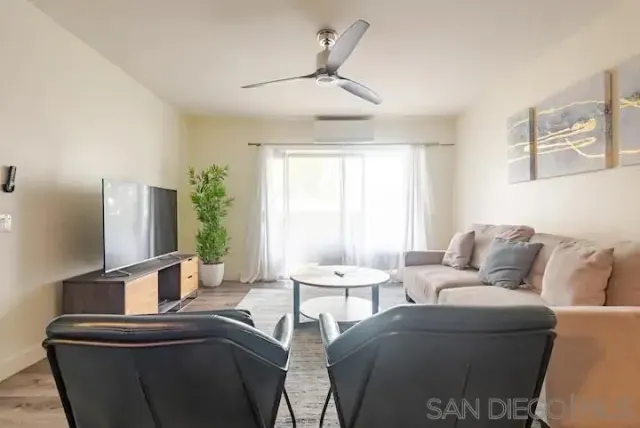 a living room with furniture and a window