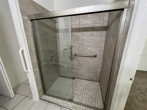 a bathroom with a glass door shower