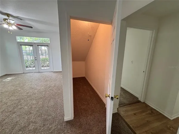 an entryway with wooden floor and a window