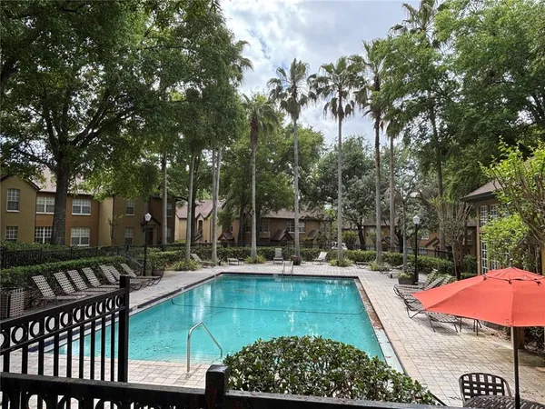 a view of a patio with swimming pool table and chairs