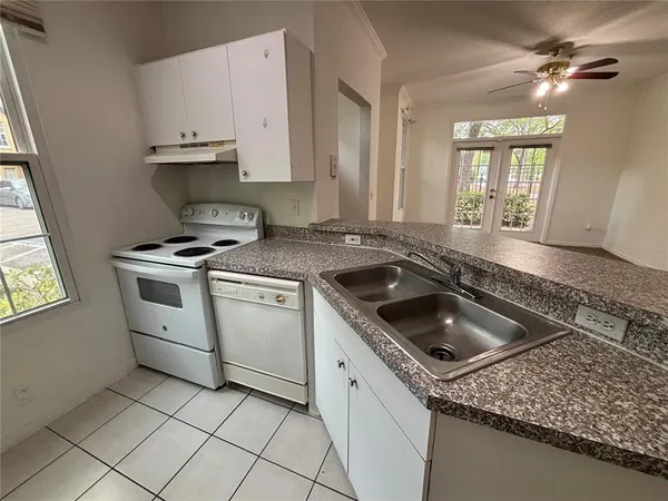 a kitchen that has a sink and a stove