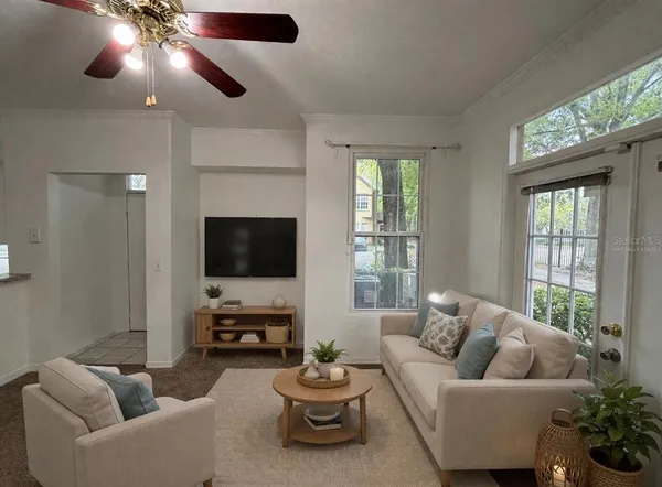 a living room with furniture and a flat screen tv