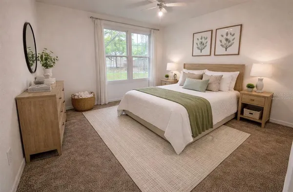 a bedroom with a bed and a potted plant