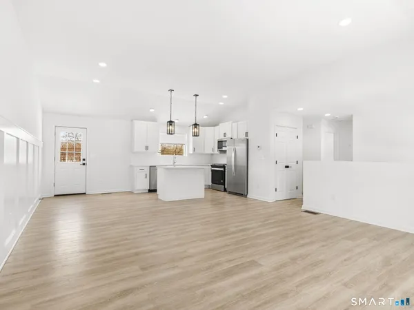 a view of a kitchen with wooden floor