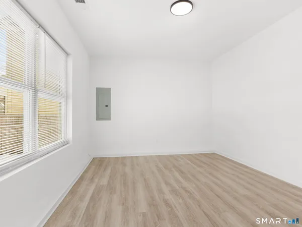 a view of a room with wooden floor and windows
