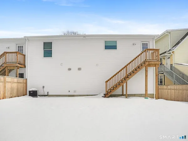 a view of a livingroom with wooden floor and stairs