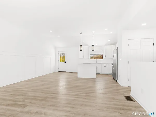 a view of a kitchen with wooden floor
