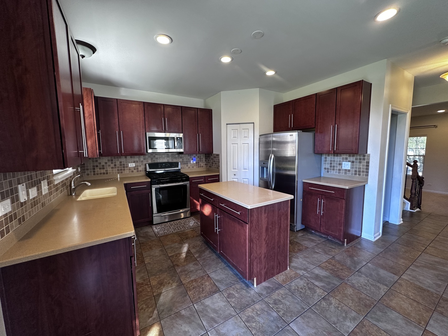 3134 Kyra Lane Elgin, IL 60124 - Photo 11 of 56 a kitchen with stainless steel appliances granite countertop wooden cabinets a stove top oven a sink and dishwasher