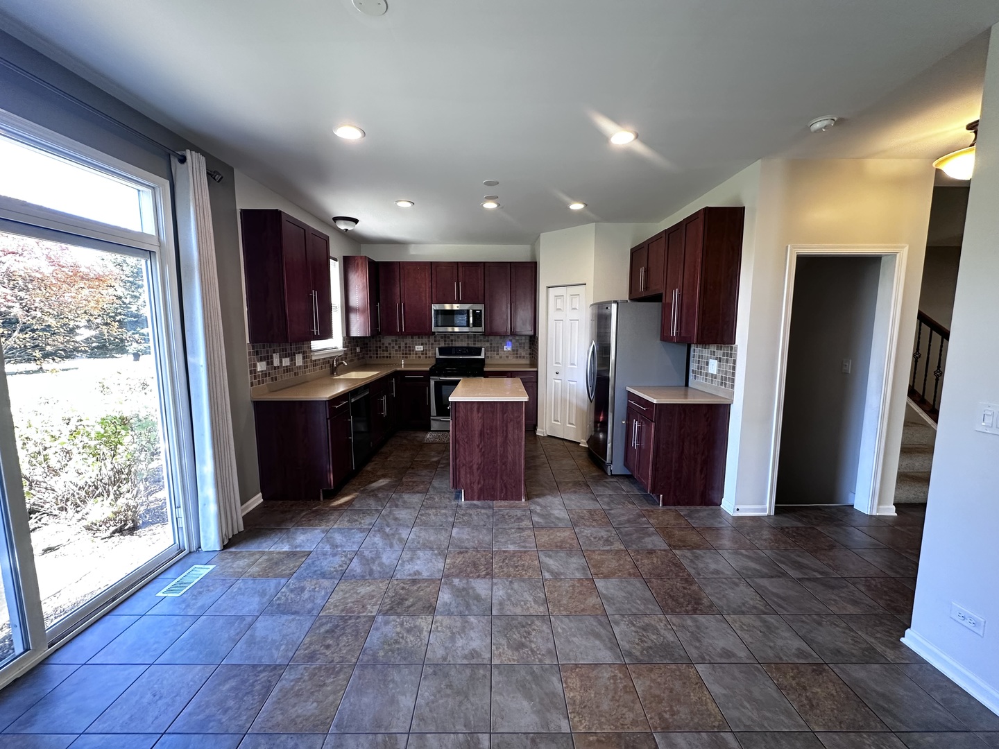 3134 Kyra Lane Elgin, IL 60124 - Photo 12 of 56 a kitchen with stainless steel appliances granite countertop a refrigerator and a stove top oven