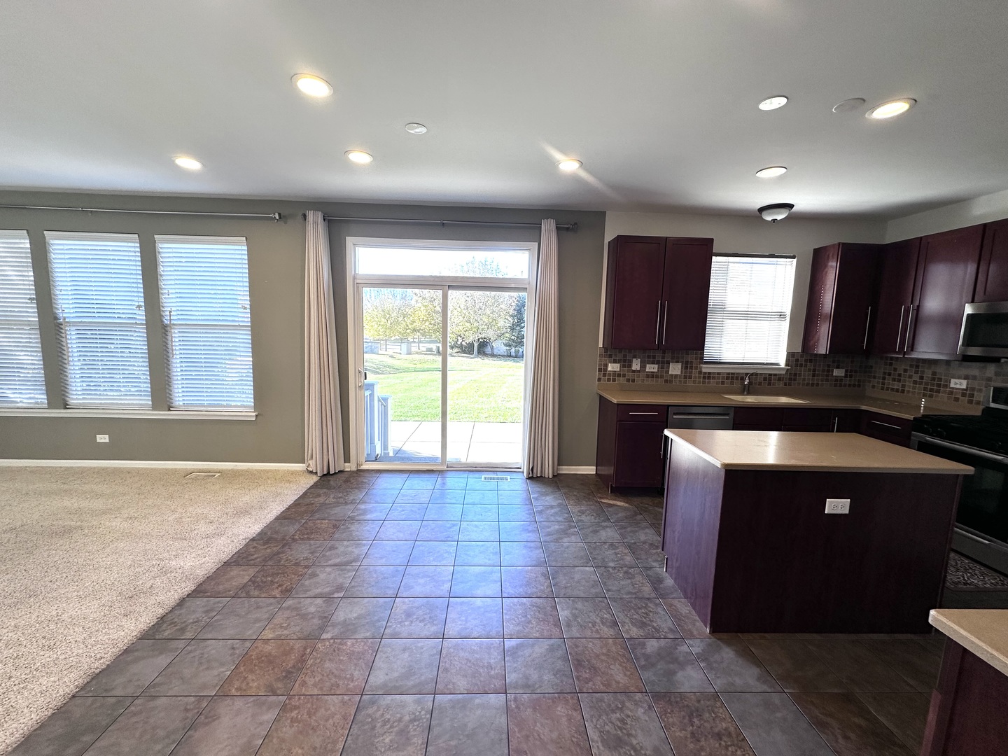 3134 Kyra Lane Elgin, IL 60124 - Photo 14 of 56 a large kitchen with stainless steel appliances granite countertop a stove a sink and a granite counter tops
