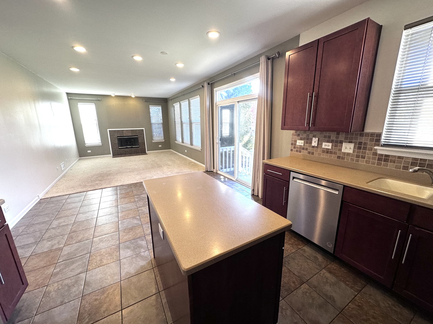 3134 Kyra Lane Elgin, IL 60124 - Photo 16 of 56 a kitchen with kitchen island granite countertop a sink a counter top space and stainless steel appliances