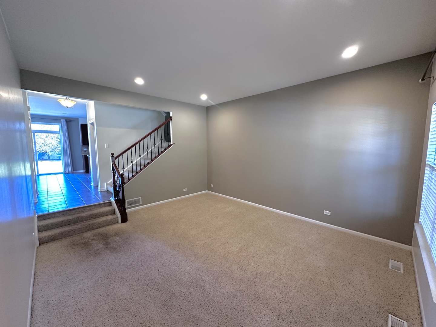 3134 Kyra Lane Elgin, IL 60124 - Photo 7 of 56 an empty room with stairs and windows