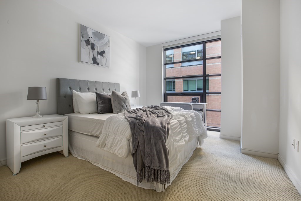 580 Washington Street, Unit 404 Boston, MA 02111 - Photo 12 of 34 a bedroom with a bed and window