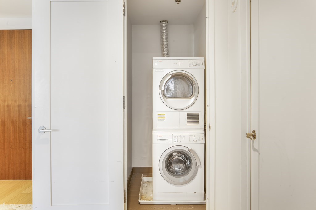 580 Washington Street, Unit 404 Boston, MA 02111 - Photo 21 of 34 a utility room with dryer and washer