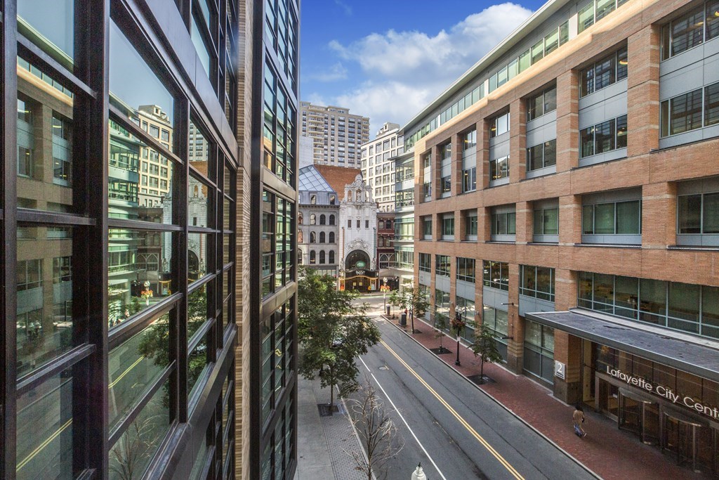 580 Washington Street, Unit 404 Boston, MA 02111 - Photo 22 of 34 a city street lined with tall buildings