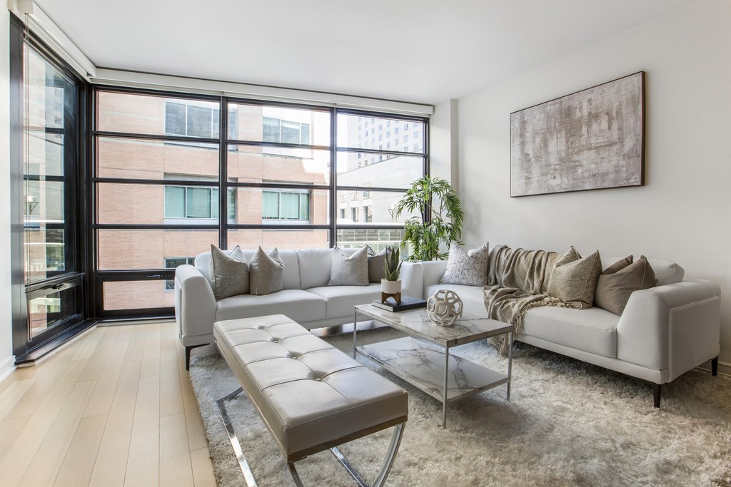580 Washington Street, Unit 404 Boston, MA 02111 - Photo 5 of 34 a living room with furniture and a large window