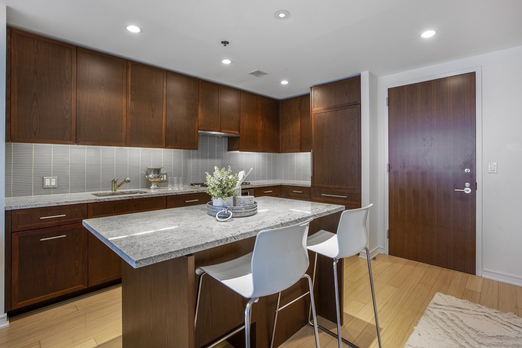 580 Washington Street, Unit 404 Boston, MA 02111 - Photo 8 of 34 a kitchen with a table and chairs in it