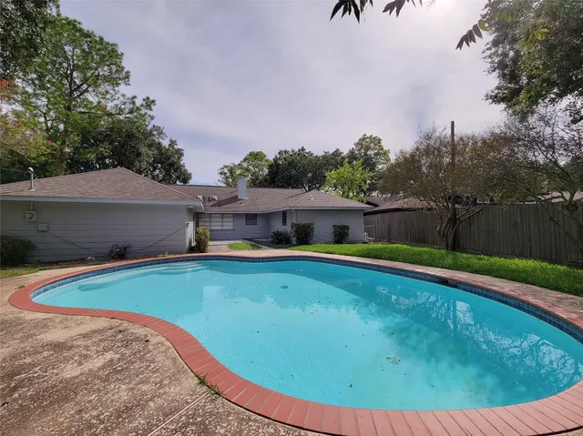 a view of a swimming pool with a yard
