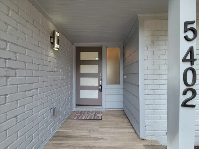 a view of an entryway door with wooden door