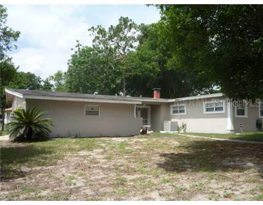 5816 Wolf Road Orlando, FL 32808 - Photo 1 of 1 a view of a house with a yard