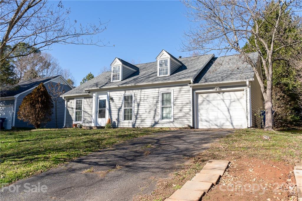 12232 Danby Road Pineville, NC 28134 - Photo 3 of 15 a front view of a house with a garden
