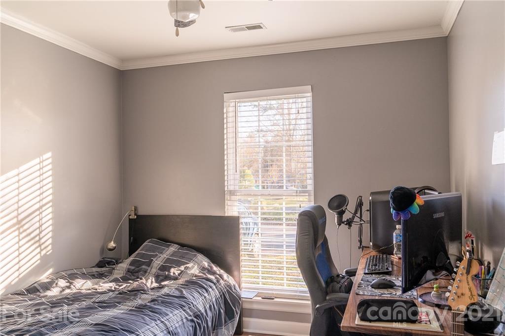 12232 Danby Road Pineville, NC 28134 - Photo 10 of 15 a bedroom with a bed and windows