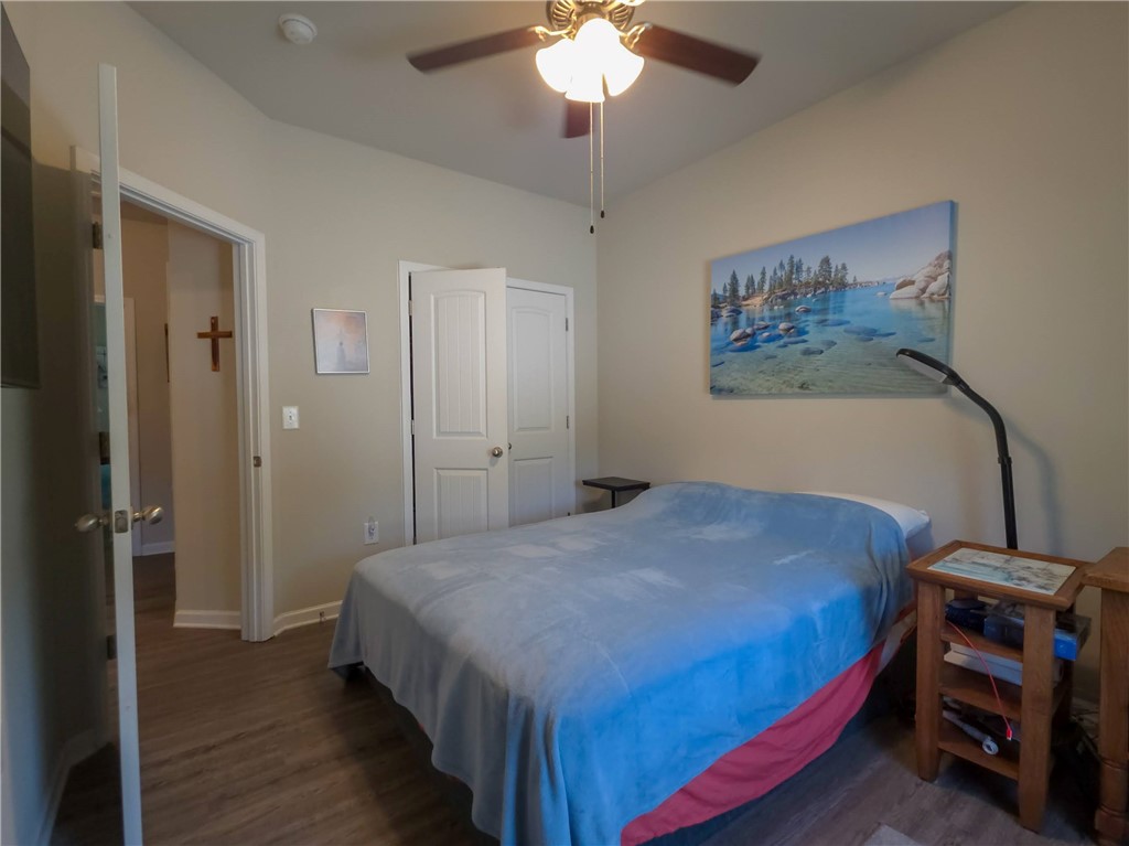 3 Cringle Lane Anderson, SC 29625 - Photo 13 of 26 Well-lit sleeping quarters with rich wood-look flooring and a functional overhead fan.