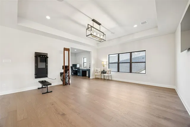 a view of a livingroom with hardwood floor and hallway