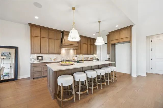 a kitchen with a dining table chairs sink and cabinets