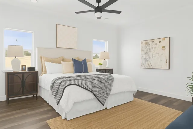 a bedroom with a bed and painting on the wall